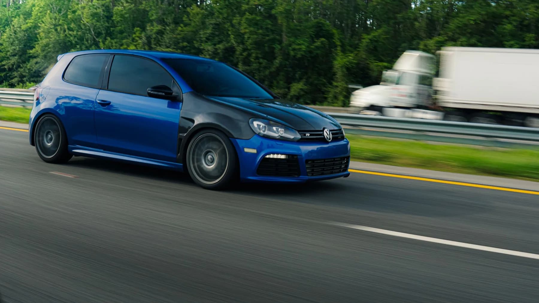 Blue hatchback driving on an open road